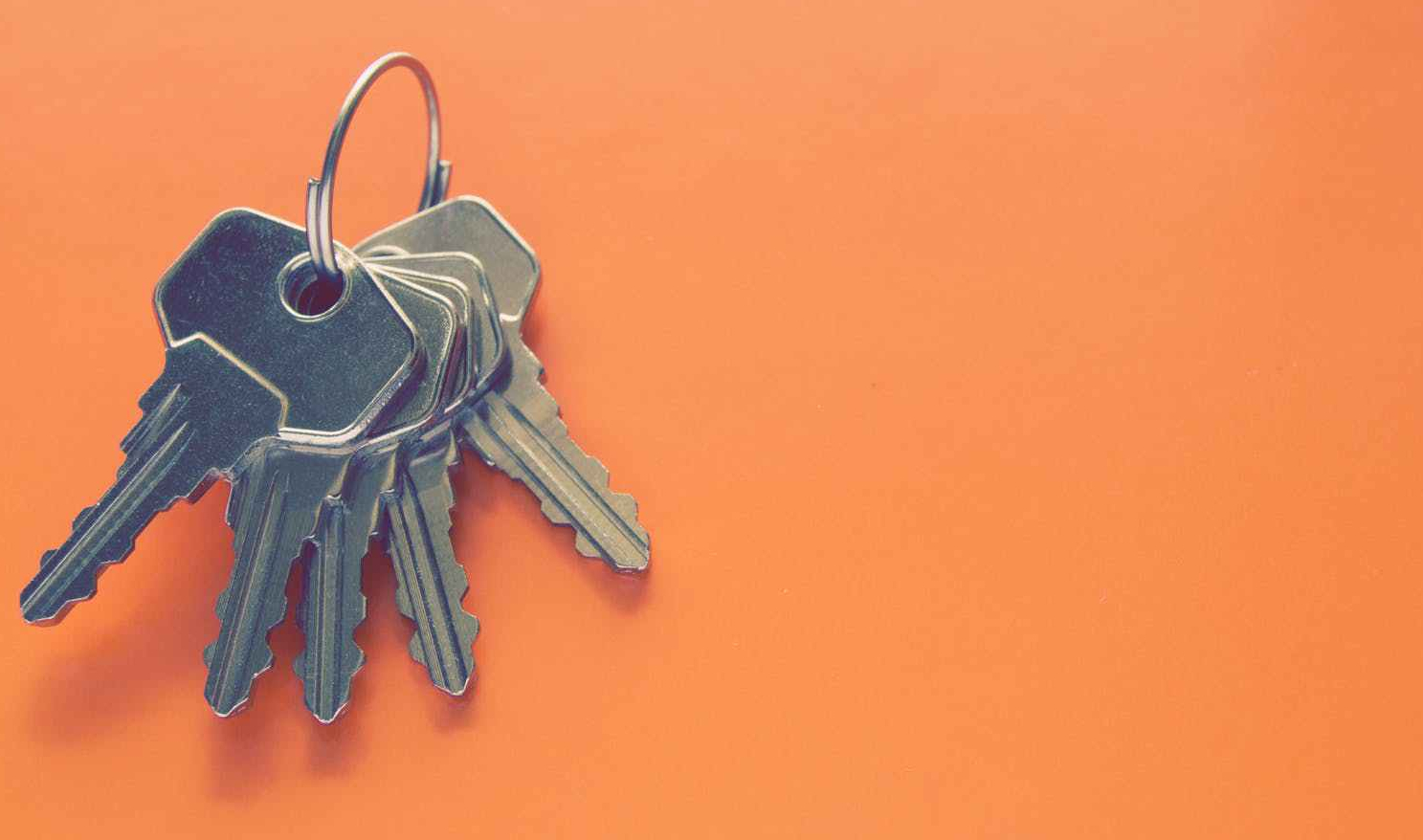 photography of keys on orange surface